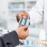 Close,Up,Hands,Of,Handsome,Asian,Male,Selling,Pharmacist,And