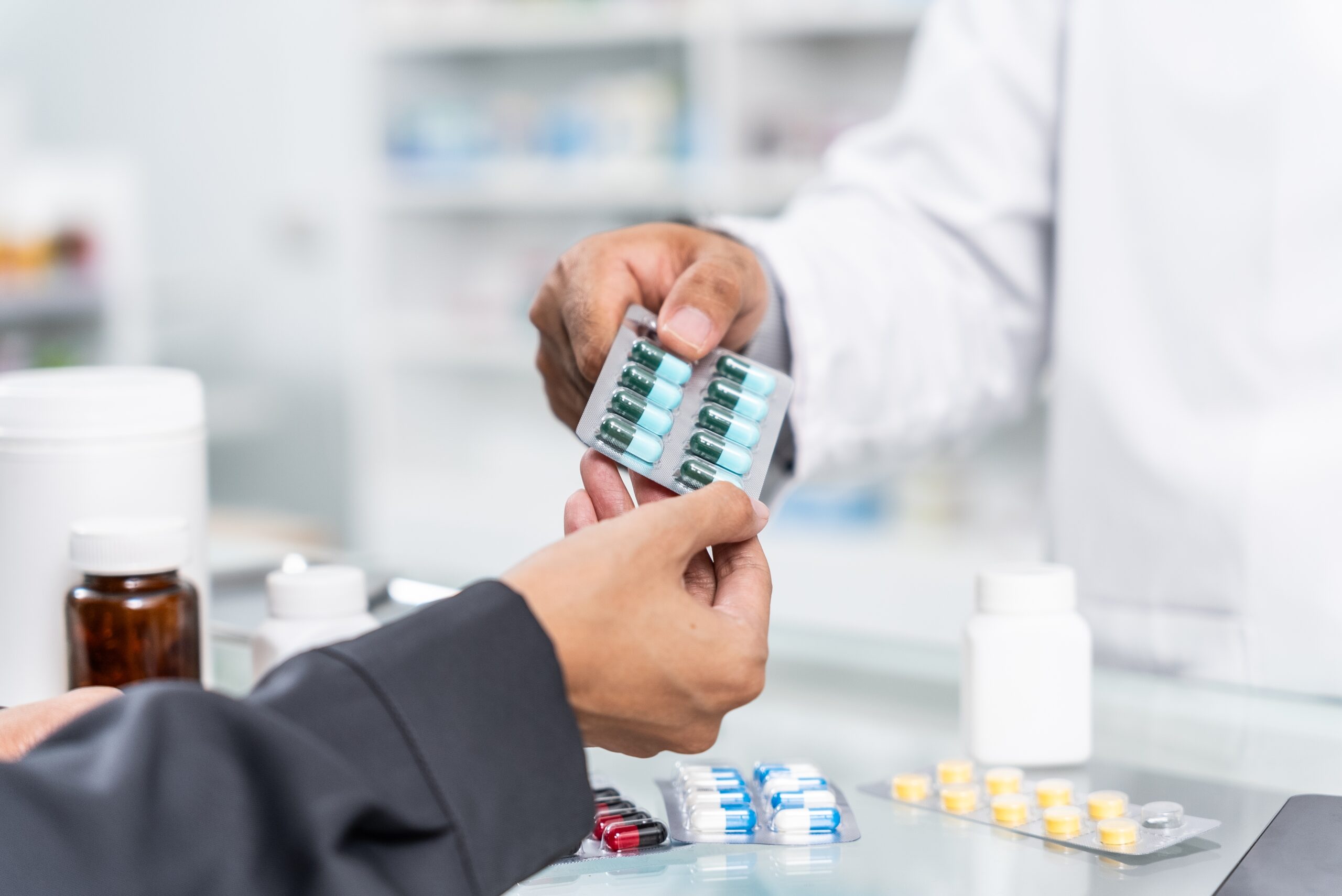 Close,Up,Hands,Of,Handsome,Asian,Male,Selling,Pharmacist,And